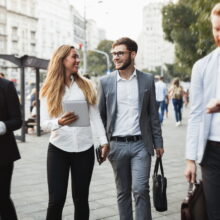 Business colleagues walking and talking on city streets