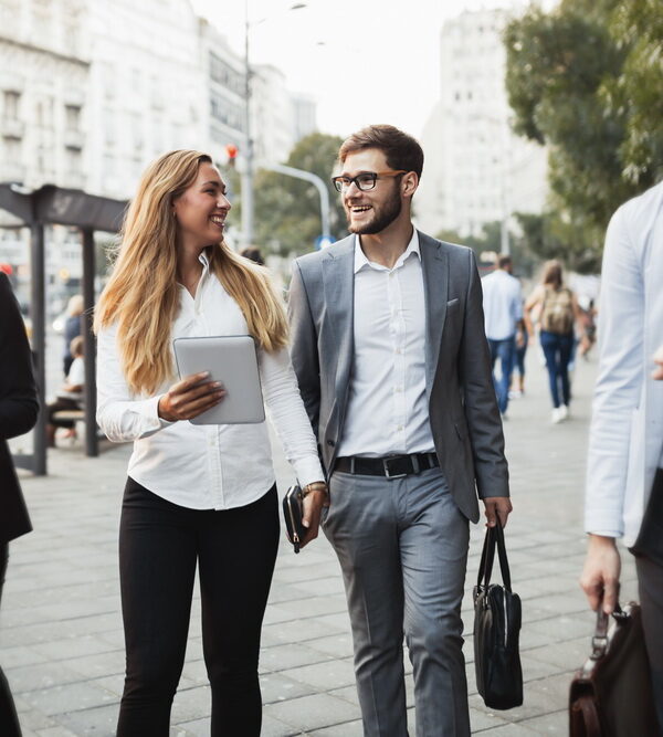 Business colleagues walking and talking on city streets