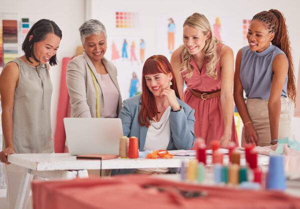 Business people, laptop and fashion meeting for marketing, clothing or ecommerce at the office. Gro.