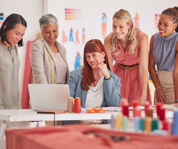 Business people, laptop and fashion meeting for marketing, clothing or ecommerce at the office. Gro.