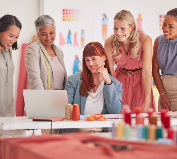 Business people, laptop and fashion meeting for marketing, clothing or ecommerce at the office. Gro.